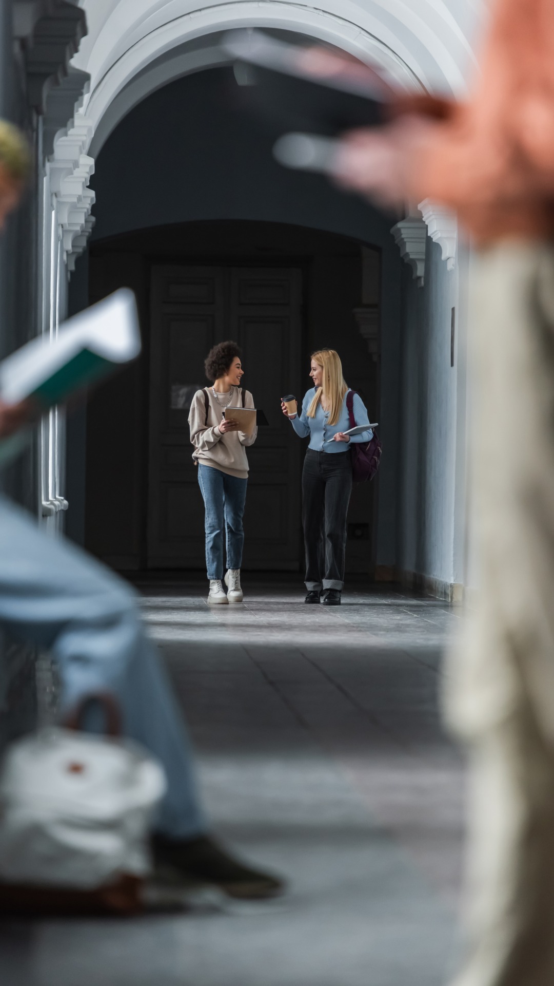 Two college students exiting a university building.